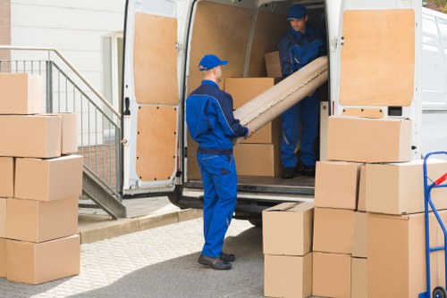 Same day removals team loading boxes in Tufnell Park street setting