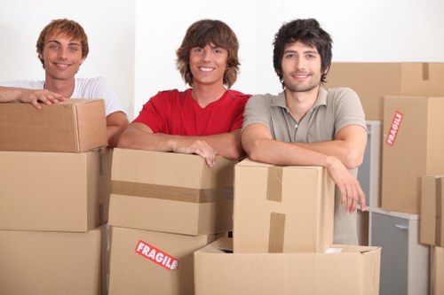 Local piano movers preparing a piano for transport near Tufnell Park homes and flats