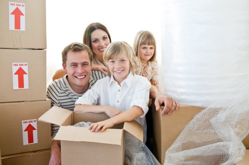 Professional movers transporting furniture through a Tufnell Park property